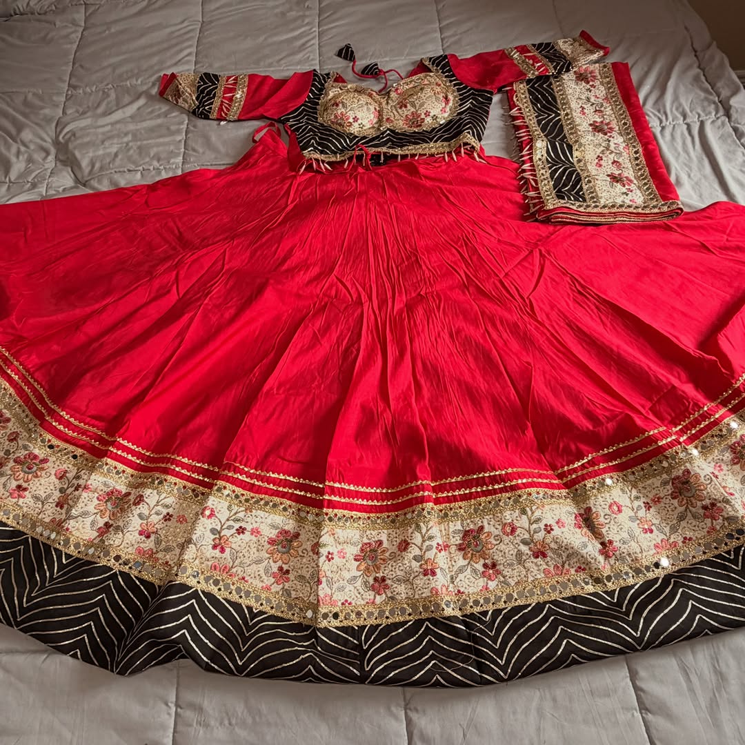 Crimson lehenga with floral gota trim over zebra stripe underlay
